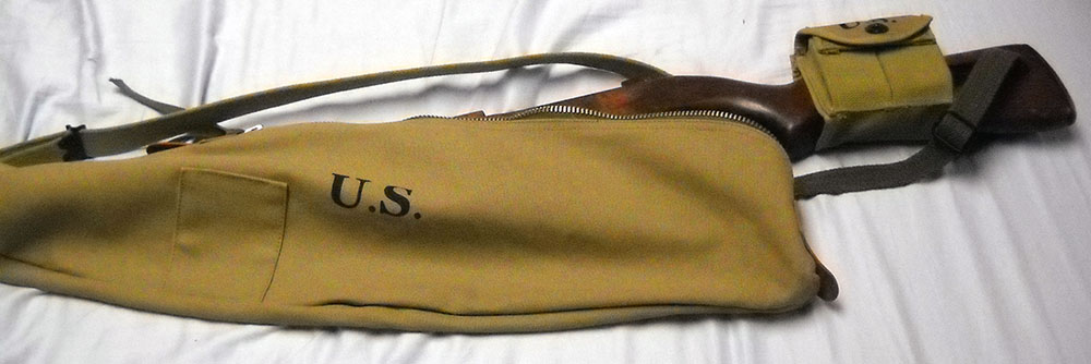 M1 carbine, partially inserted in reproduction GI carrying case
